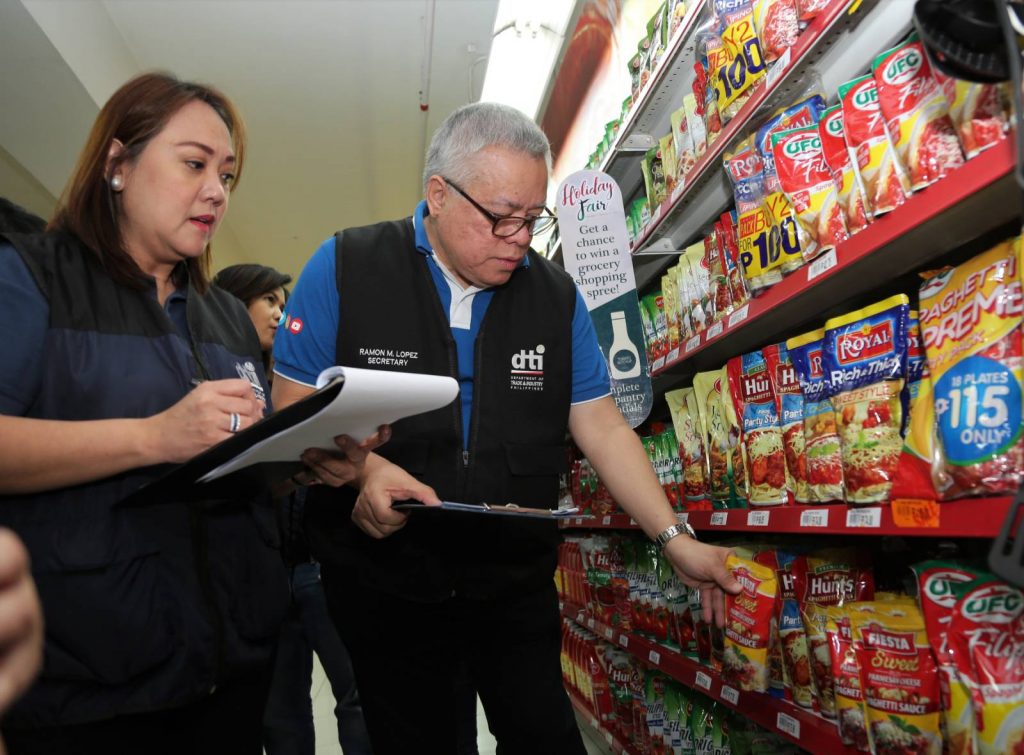 DTI Sec. Lopez and CPG Usec. Castelo inspecting prices of products in a grocery