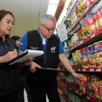 DTI Sec. Lopez and CPG Usec. Castelo inspecting prices of products in a grocery