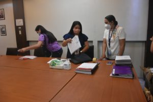 Ms. Glaiza Muzares and Ms. Ms. Jhoana Marie M. Ong examining documents that needs to be disposed.