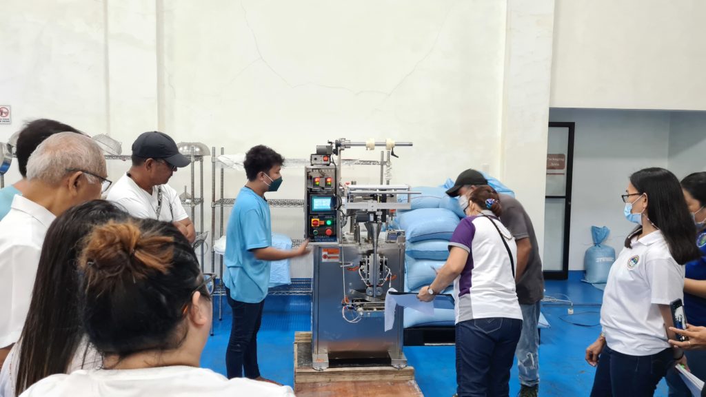 Personnel from  Alabat Island Farmers Producers Cooperative and DTI SSF Quezon inspecting the Coco Sap Sweetener machine