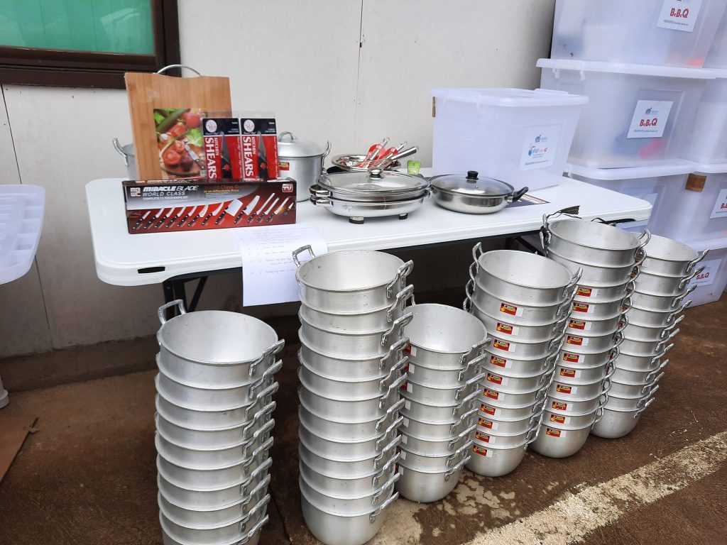 A photo of stacked cooking pots ready for dsitribution