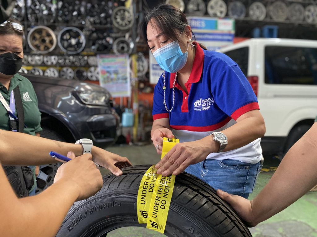 Consumer Protection Group (CPG) Undersecretary Atty. Ruth B. Castelo sealing uncertified tires for automotive vehicles from a firm in Parañaque..