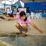 participant making a rattan basket
