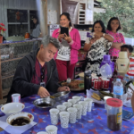 Instructor demonstrates methodologies for planting coffee