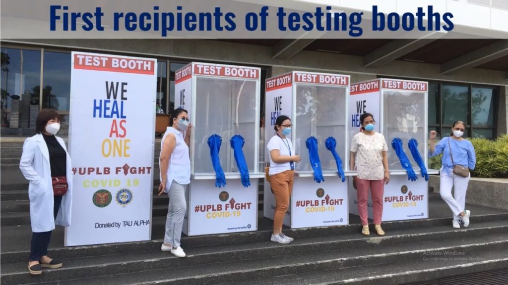 Women standing in front of testing booths they have received