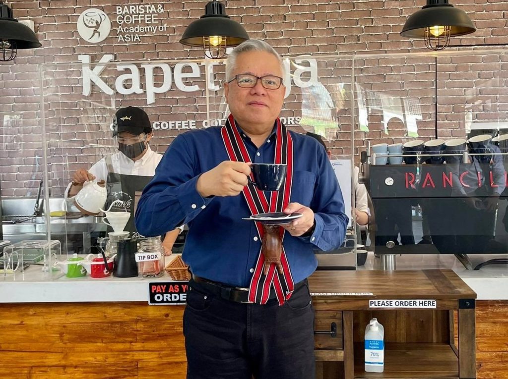 DTI Secretary Mon Lopez enjoying a cup of locally produced coffee at the Kapetirya