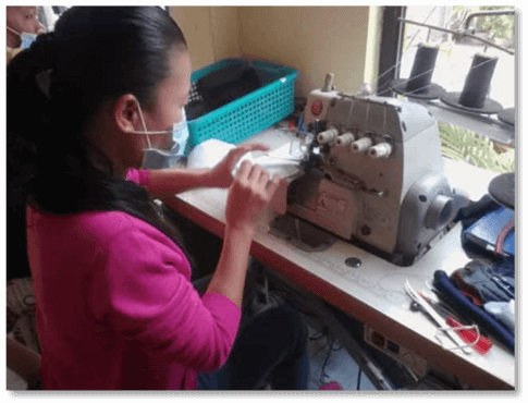 A FRL Trading employee making washable face mask