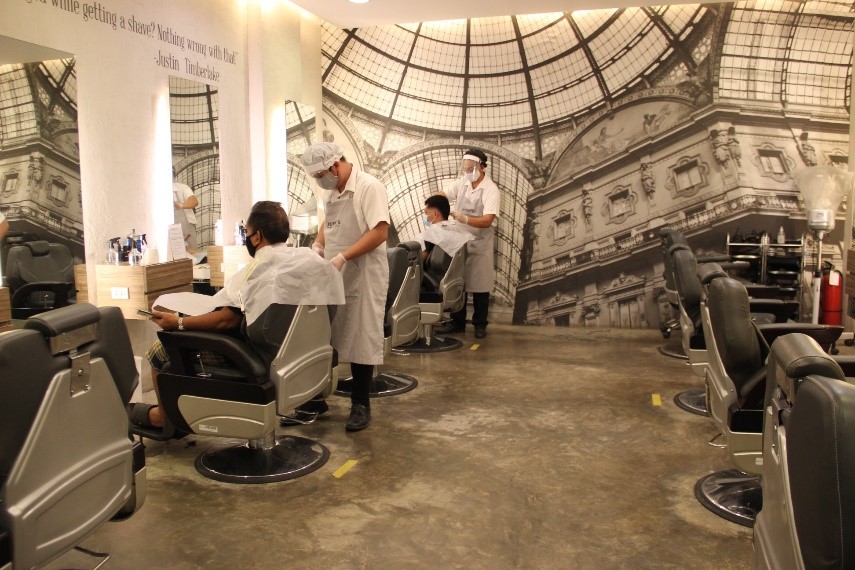 Barbers were seen in complete PPEs while servicing customers in a barbershop visited by employees from DTI, DOLE, and the local government unit.  