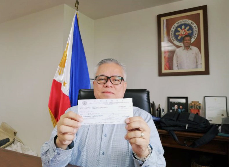 Secretary Lopez presents the check for 1 million pesos worth of financial assistance to CITEM