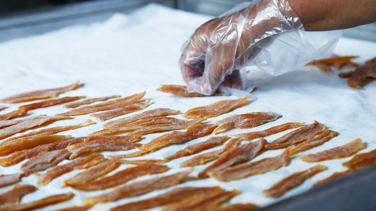 Strips of dried mangoes ready for packaging